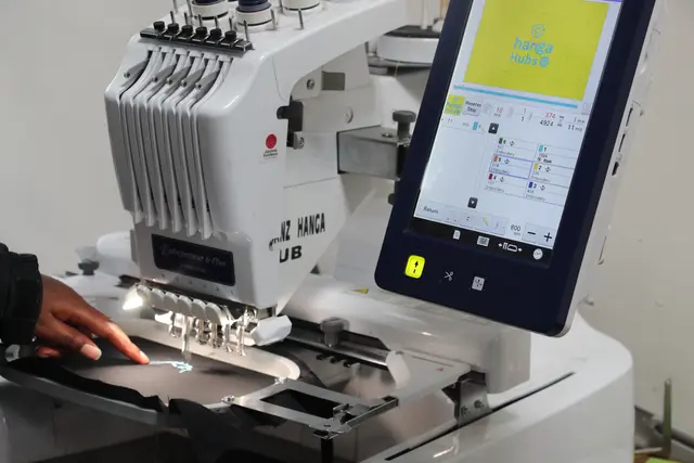 Close-up of a person operating an embroidery machine
